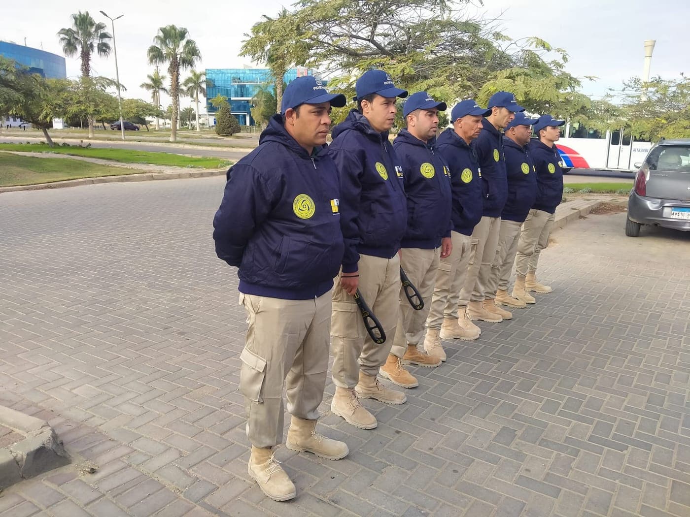 FM+ security guards lined up at a gate before their shift