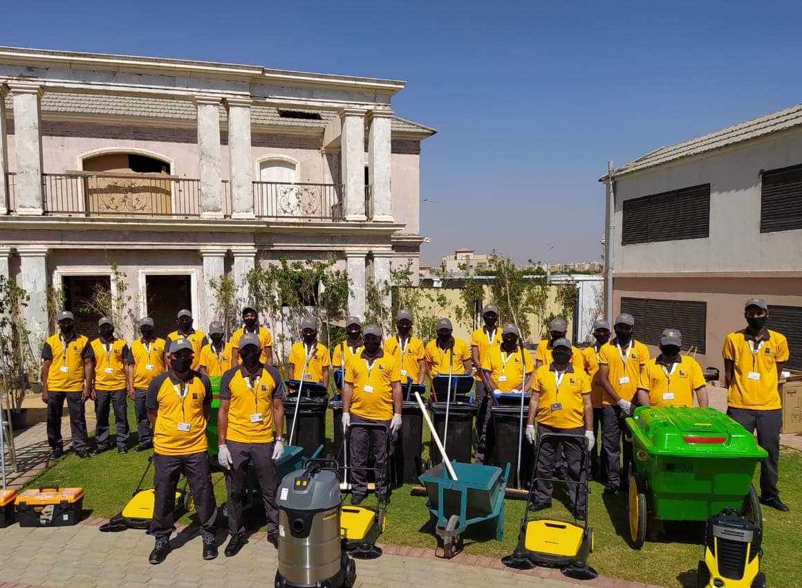 FM+ cleaning crew with their machines, carts and supplies